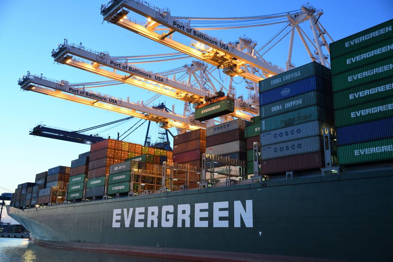 Container ship loading at a port during the day