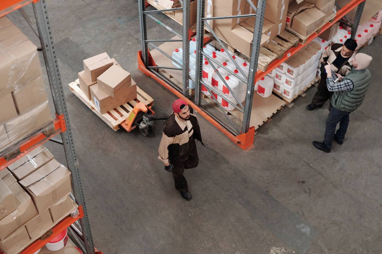 Warehouse workers organizing pallets of cargo